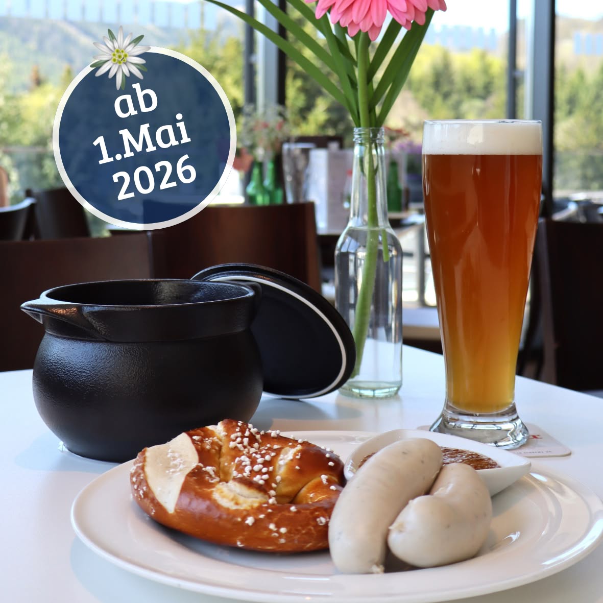 Weißwurst with a pretzel, wheat beer, and a black pot on a set table, starting May 1, 2026, at the Parkhotel Hirschwang.